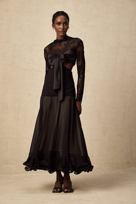 A long maxi dress with floral lace panels and a combination of solid and sheer fabric featuring a feminine silhouette and delicate floral patterns throughout