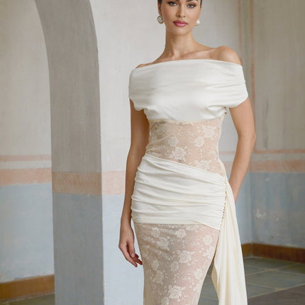 A long maxi dress with floral lace panels and ribbon details in neutral colors featuring a feminine and elegant design