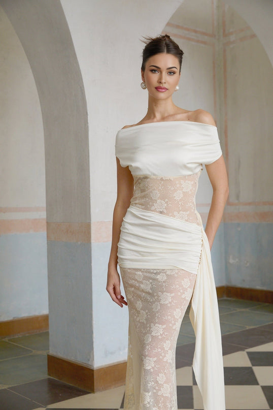 A long maxi dress with floral lace panels and ribbon details in neutral colors featuring a feminine and elegant design