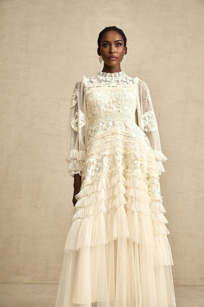 A long maxi dress with layered tulle skirt featuring floral embroidery in a capucine color