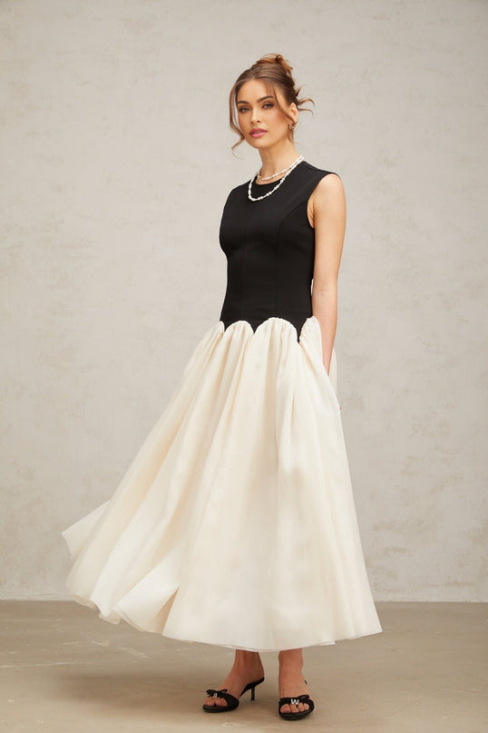 A long maxi dress with puffed sleeves featuring colorblocked panels in contrasting shades named Josette