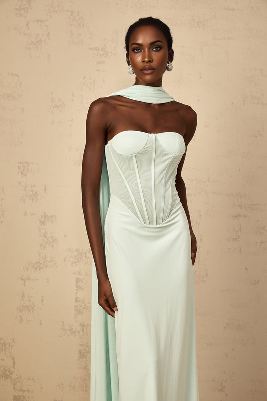 A long mint green maxi dress with a tulle panel and corsetstyle bodice featuring a sweetheart neckline and flowy skirt