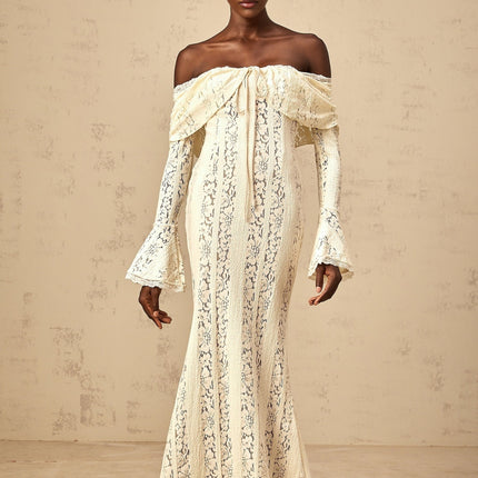 A long neutral colored maxi dress with floral lace details and a train design featuring delicate patterns and a flowing silhouette