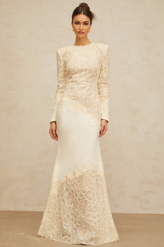 A long offwhite maxi dress with textured floral embroidery and sequin details named Mathilde