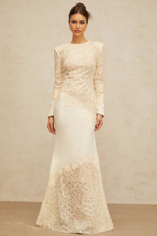A long offwhite maxi dress with textured floral embroidery and sequin details named Mathilde
