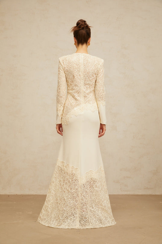 A long offwhite maxi dress with textured floral embroidery and sequin details named Mathilde