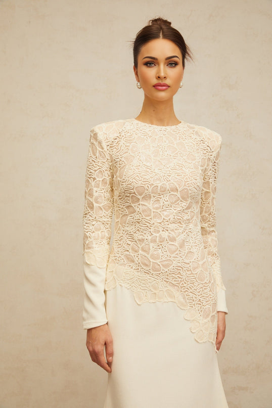 A long offwhite maxi dress with textured floral embroidery and sequin details named Mathilde