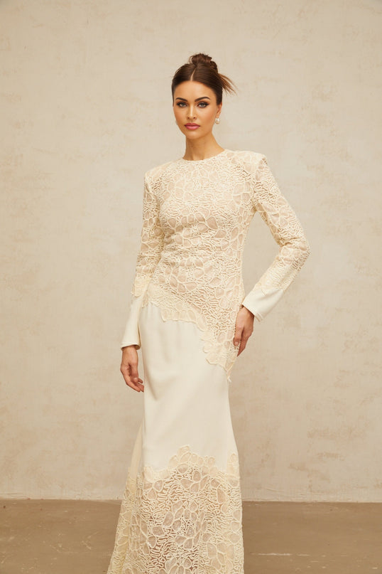 A long offwhite maxi dress with textured floral embroidery and sequin details named Mathilde