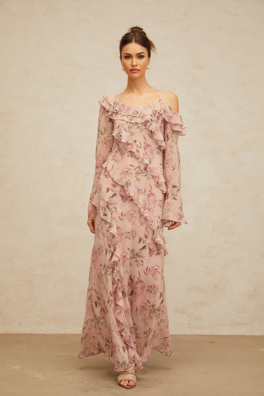 A long pink maxi dress with a floral print pattern and ruffled details named Clemence