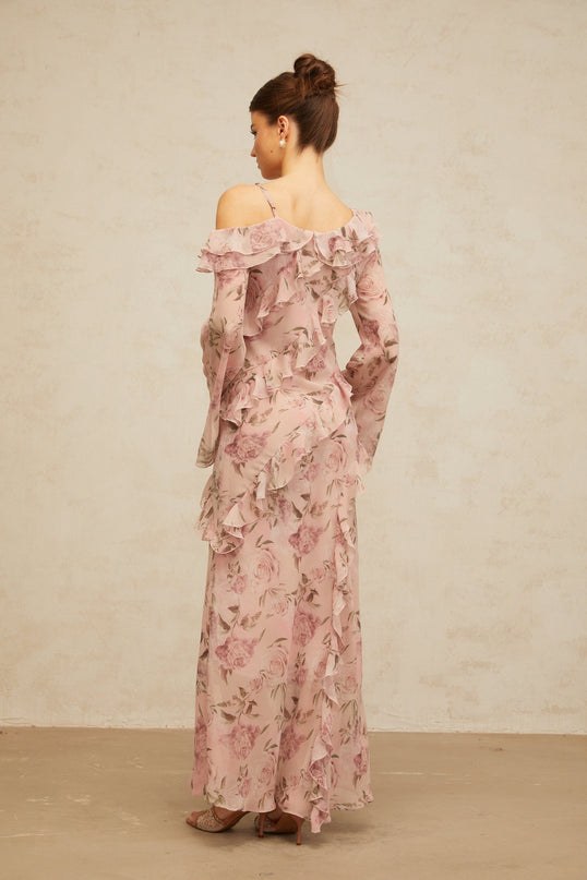 A long pink maxi dress with a floral print pattern and ruffled details