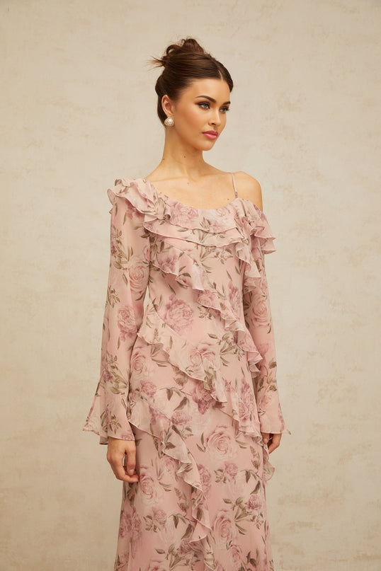 A long pink maxi dress with a floral print pattern and ruffled details