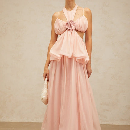 A long pink maxi dress with floral applique details and cut out sections featuring a flowing silhouette and delicate design