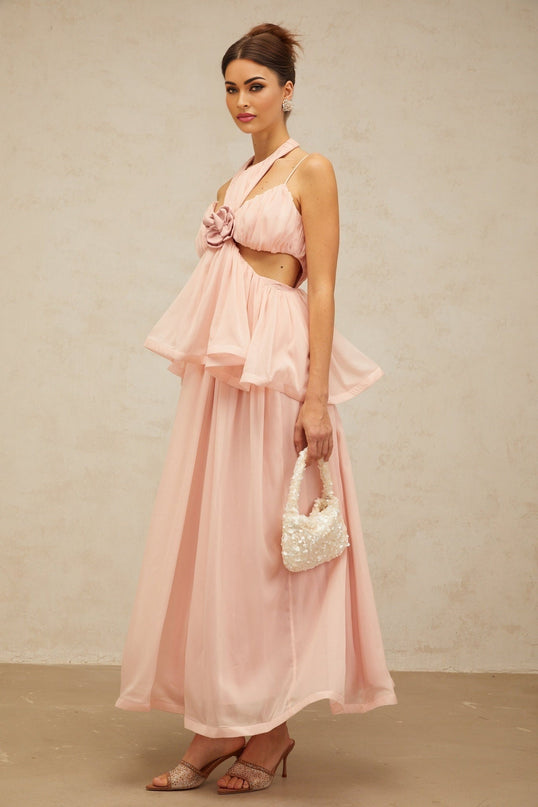 A long pink maxi dress with floral applique details and cut out sections featuring the Danae design