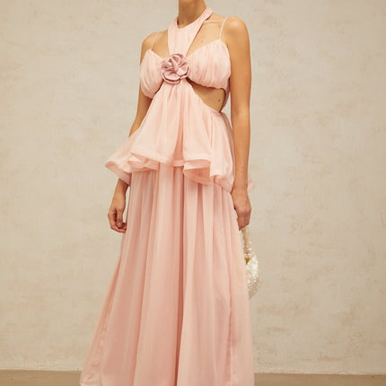 A long pink maxi dress with floral applique details and strategic cutouts