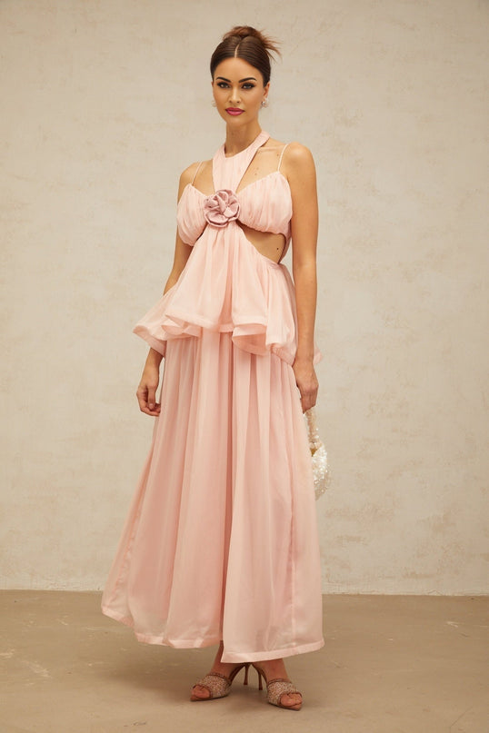 A long pink maxi dress with floral applique details and strategic cutouts