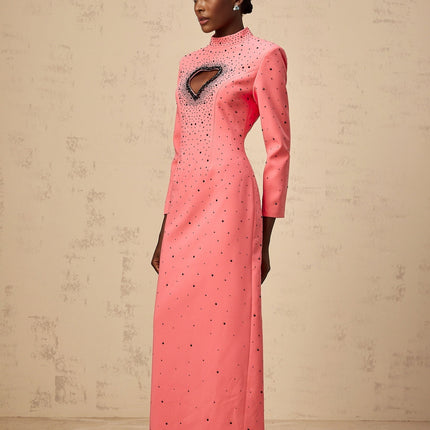 A long pink maxi dress with heart shaped cutouts and embellishments named Zelie