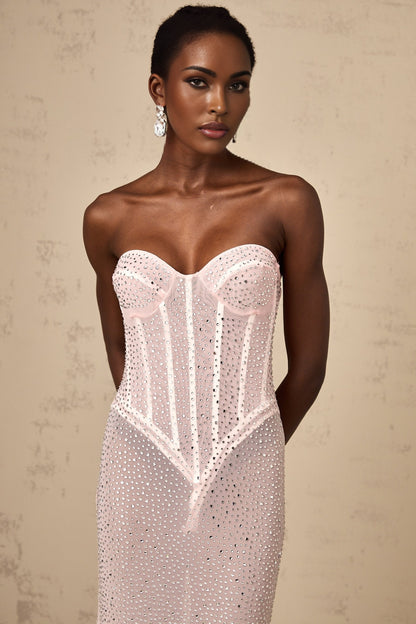 A long pink maxi dress with rhinestone embellishments and semi sheer fabric featuring a flowing silhouette and sparkling details