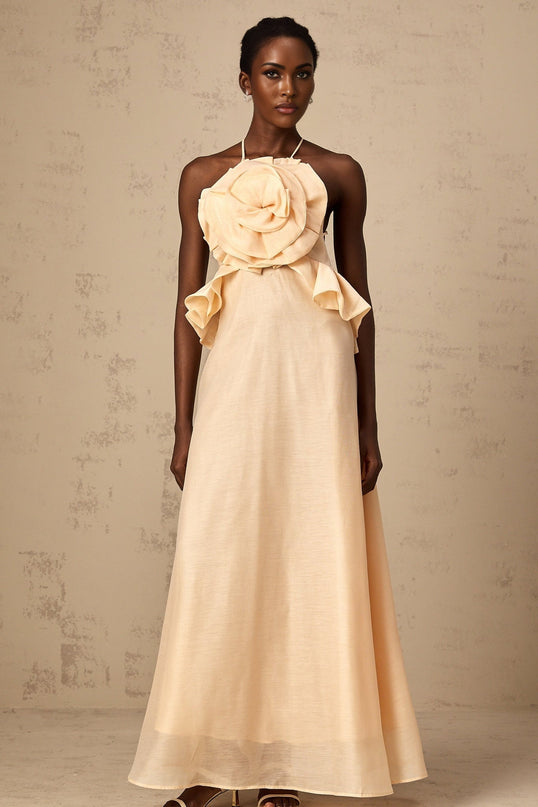 A long pink maxi dress with ruffled 3d petal details covering the entire garment creating a textured and voluminous appearance