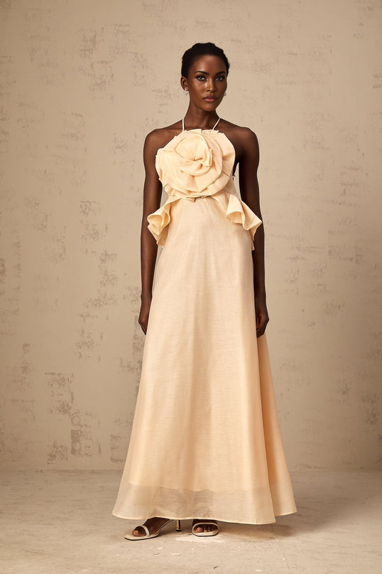 A long pink maxi dress with ruffled 3d petal details covering the entire garment creating a textured floral appearance