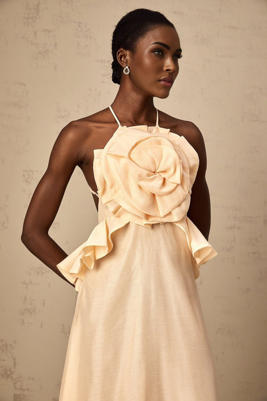 A long pink maxi dress with ruffled 3d petal details throughout creating a textured floral effect