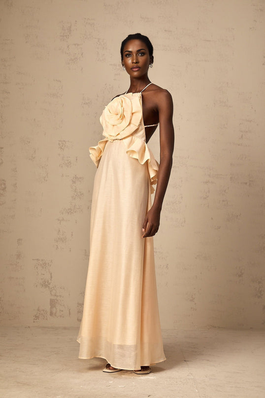 A long pink maxi dress with ruffled 3d petal details throughout the bodice and skirt creating a layered floral effect