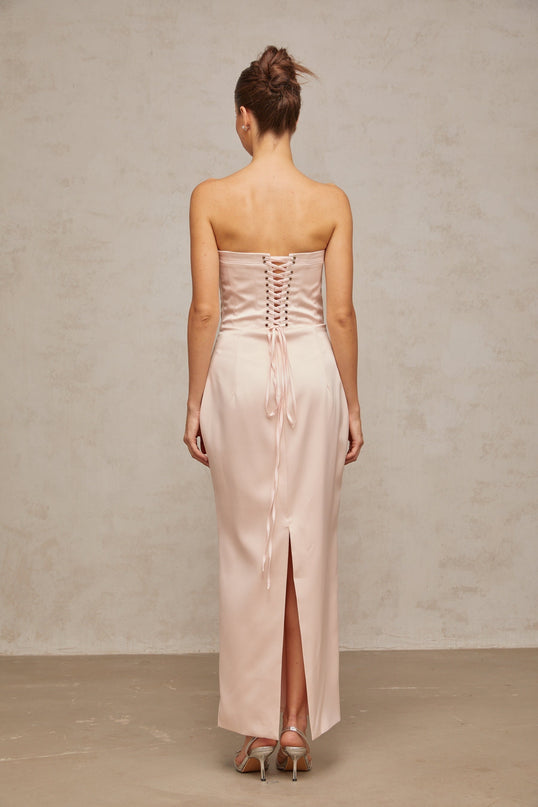 A long pink satin maxi dress with an offshoulder corset style bodice