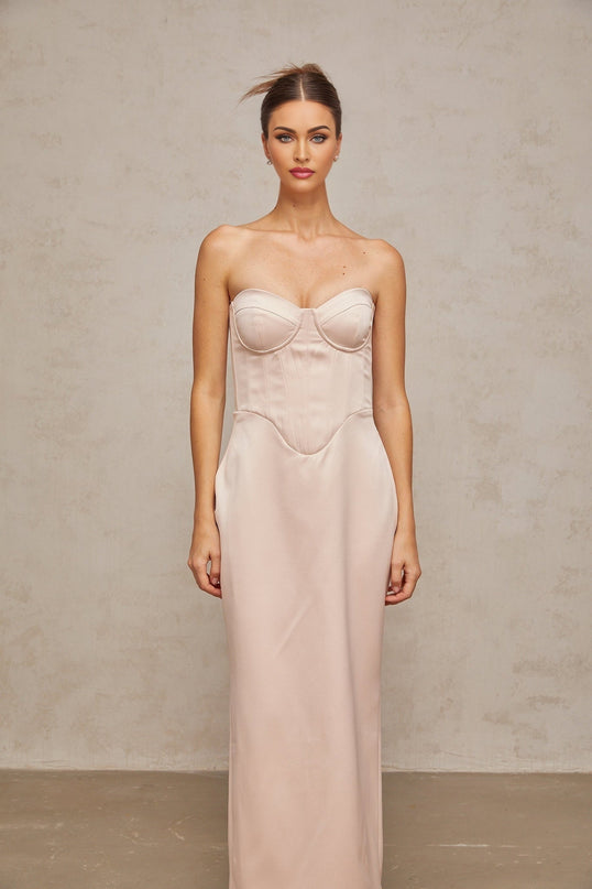 A long pink satin maxi dress with an offshoulder corset style bodice