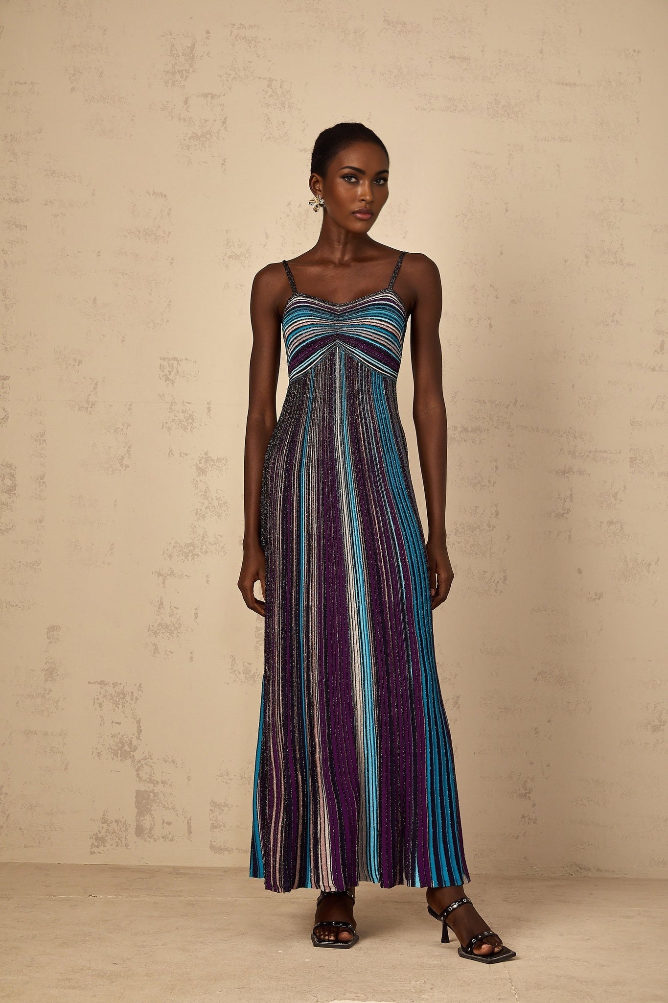 A long purple maxi dress for women featuring horizontal stripes of sequins across the knit fabric