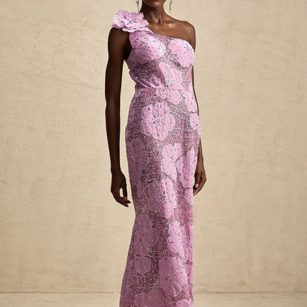 A long purple maxi dress with floral applique details adorning the fabric