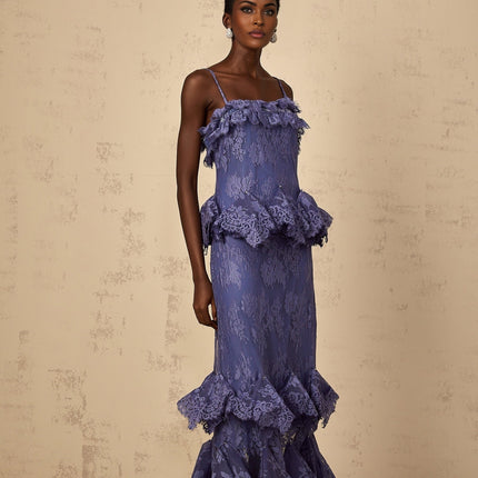 A long purple maxi dress with floral lace pattern and ruffled details featuring a feminine silhouette