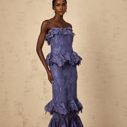 A long purple maxi dress with floral lace pattern and ruffled details featuring a feminine silhouette