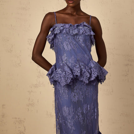 A long purple maxi dress with floral lace pattern and ruffled details