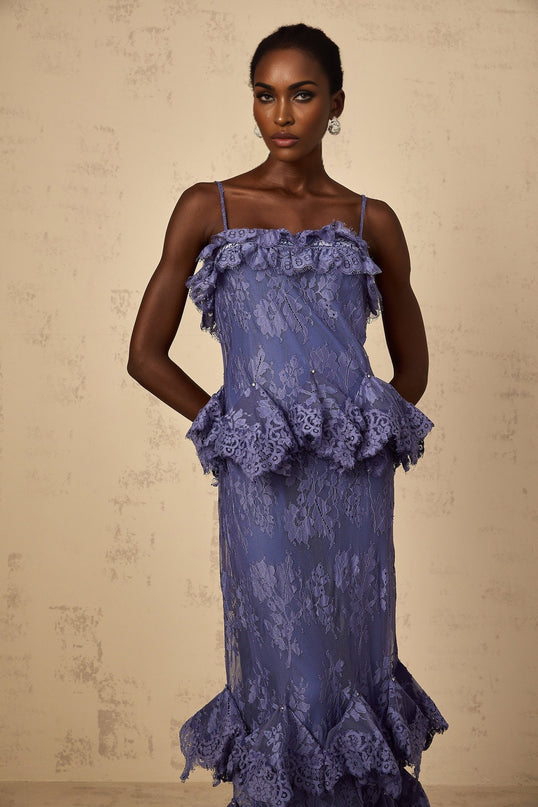 A long purple maxi dress with floral lace pattern and ruffled details