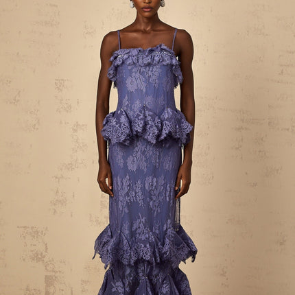 A long purple maxi dress with floral lace pattern and ruffled details