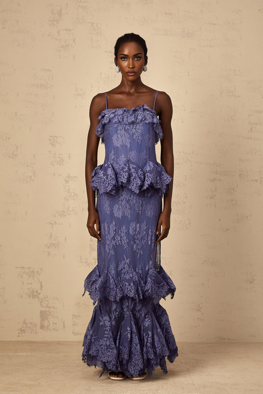 A long purple maxi dress with floral lace pattern and ruffled details