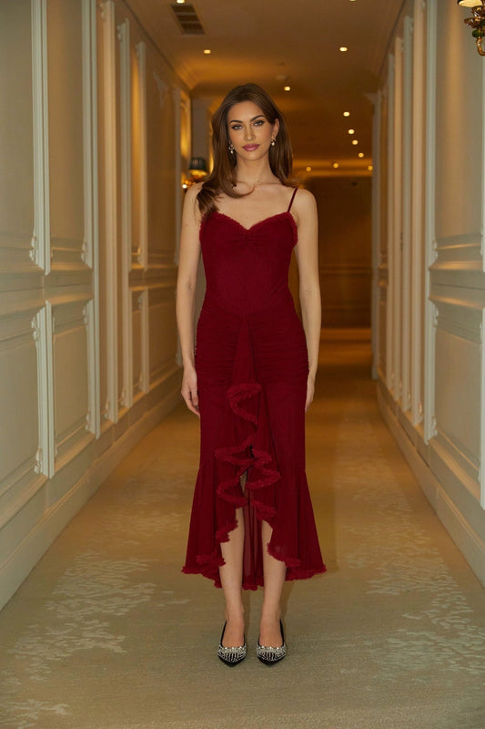 A long red maxi dress with ruffles and draped fabric detailing called the Viviane