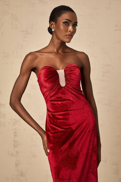 A long red velvet midi dress with gathered details and a sleek silhouette