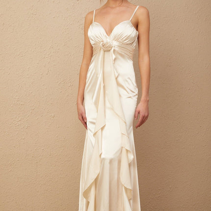 A long satin maxi dress with a corset bodice featuring floral applique details and a flowing skirt in a feminine Filomena style