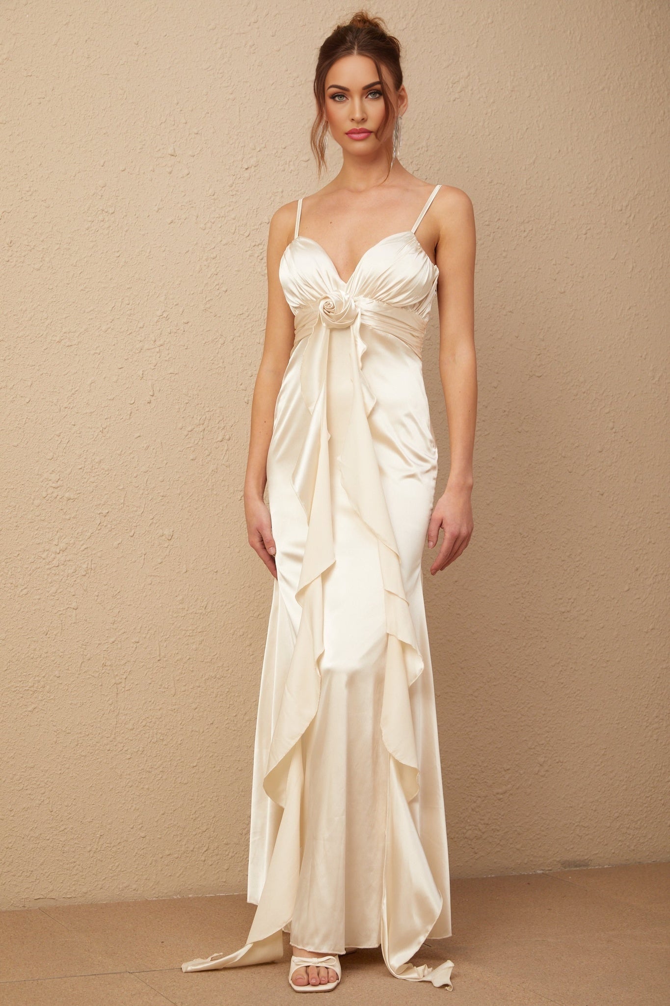 A long satin maxi dress with a corset bodice featuring floral applique details and a flowing skirt in a feminine Filomena style