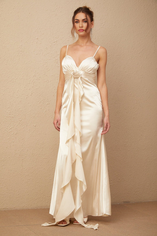A long satin maxi dress with a corset bodice featuring floral applique details and a flowing skirt