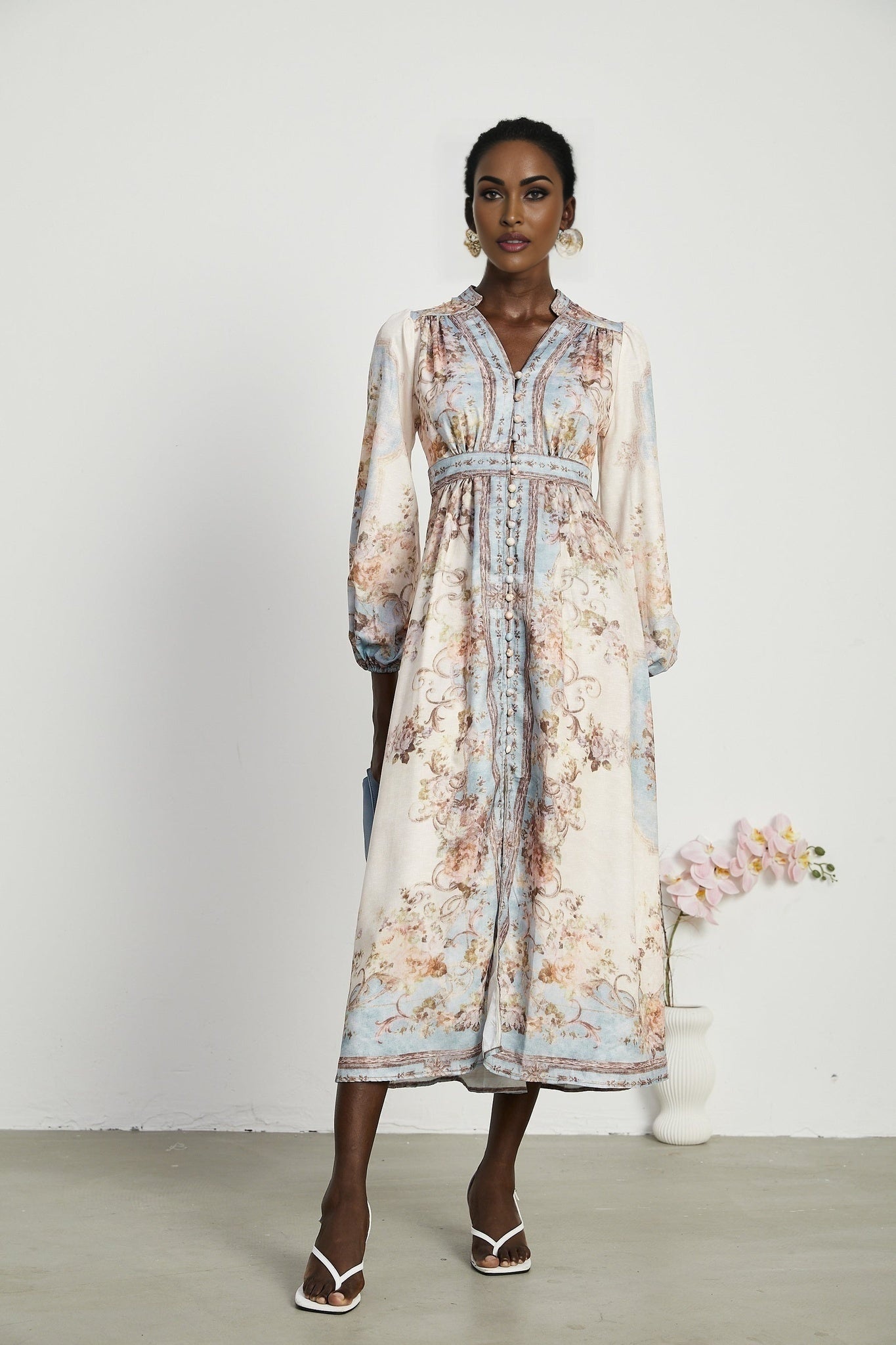 A long sleeve bohemian style dress with a floral print pattern called Camille featuring a flowing silhouette