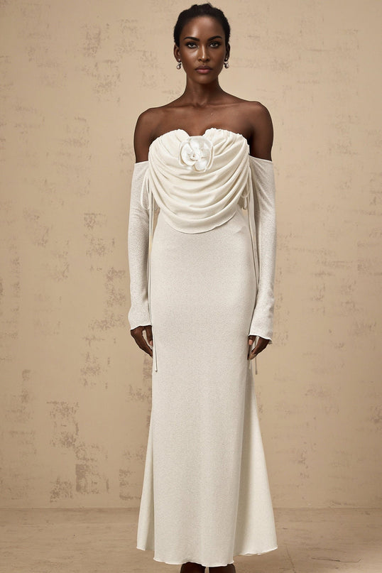 A long strapless maxi dress with a ruched bodice and floral applique details featuring a Julia design in a feminine silhouette