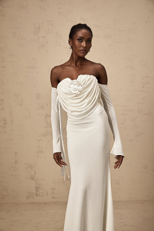 A long strapless maxi dress with ruched detailing and floral appliques featuring a vibrant Julia design