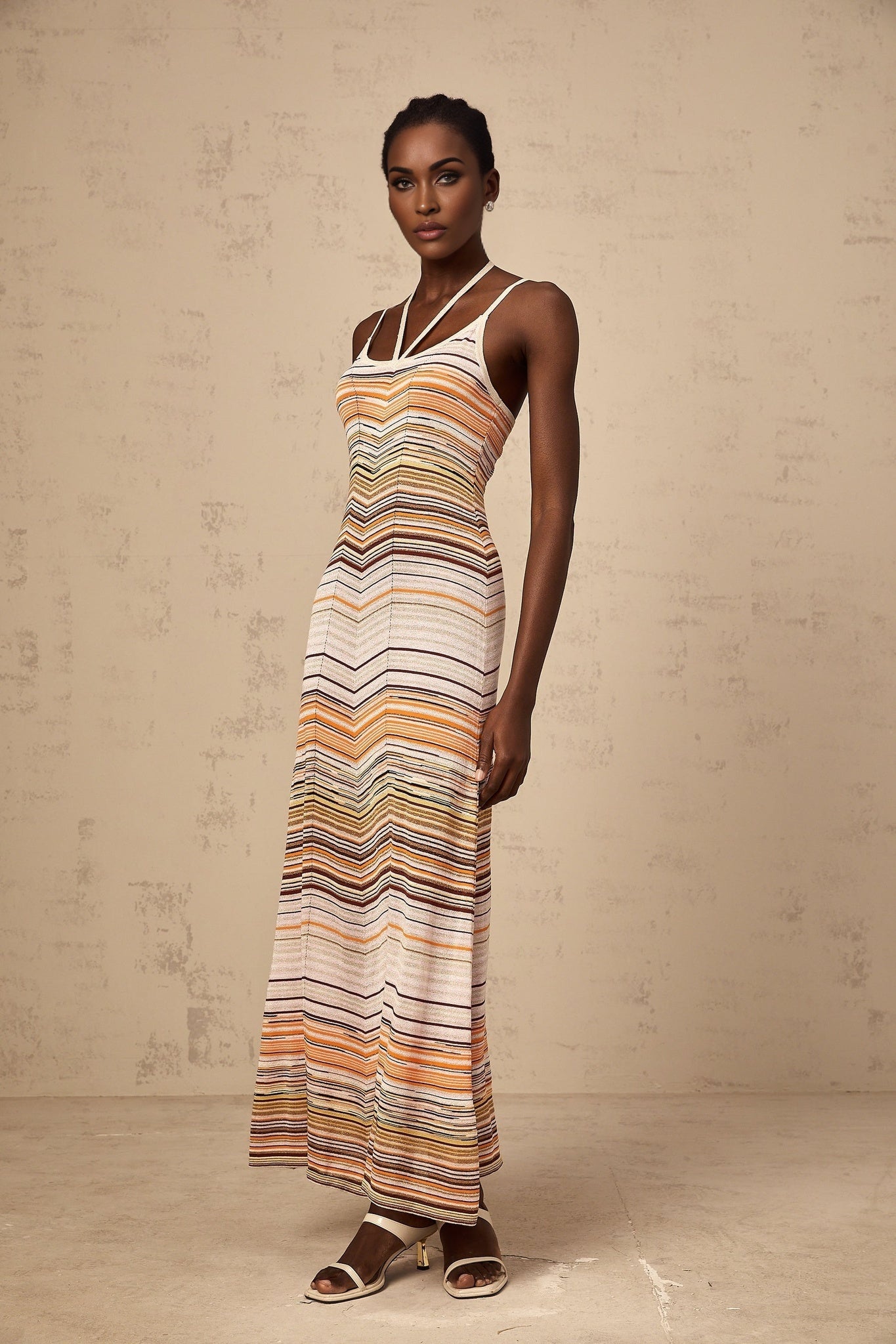 A long striped maxi dress in multiple colors featuring a knit texture by Chloe