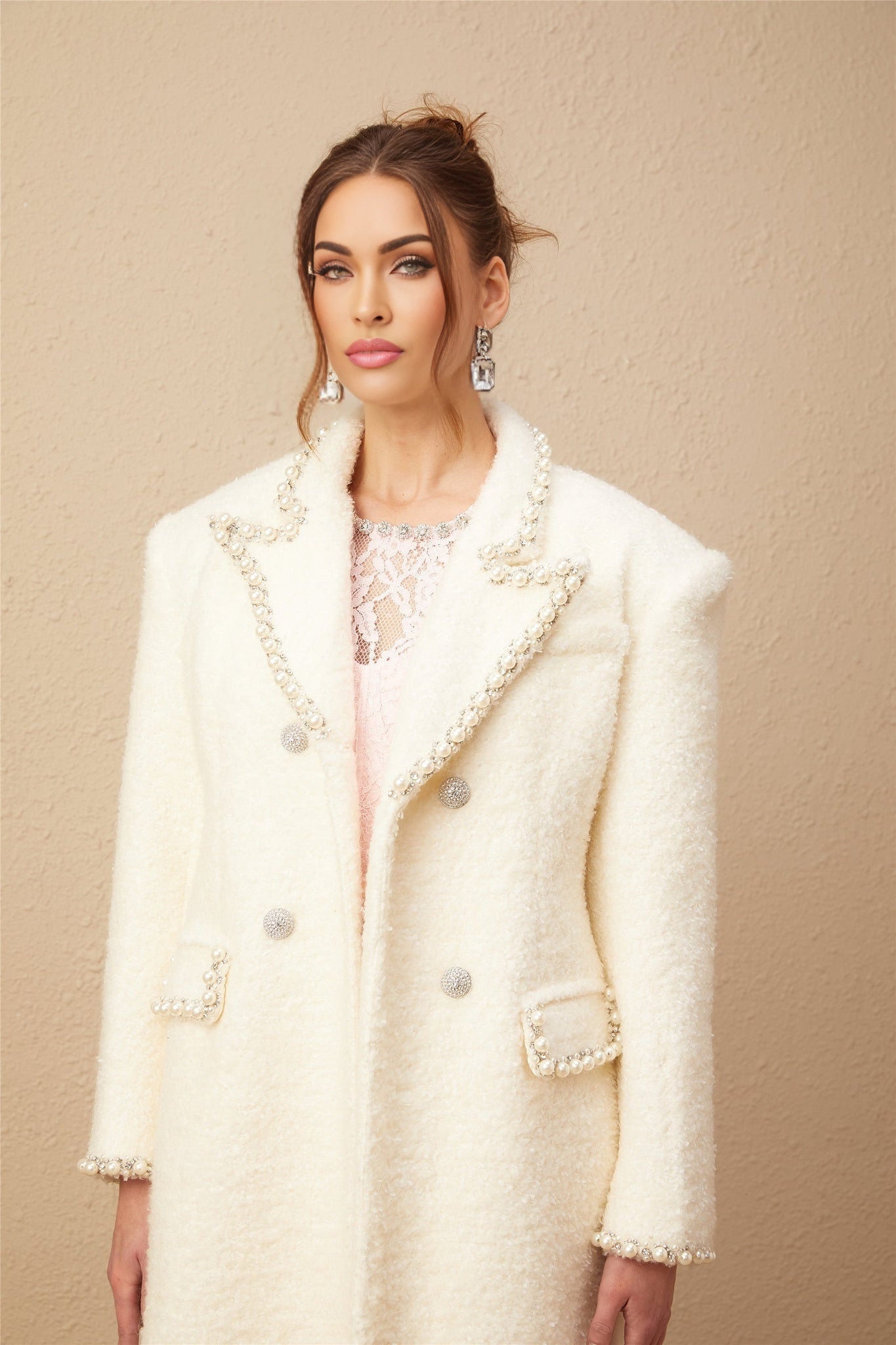 A long tweed coat in wool fabric with faux pearl embellishments called the Isotta coat