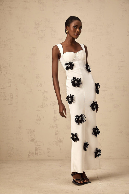 A long white bandage style maxi dress with floral applique details named Olivia