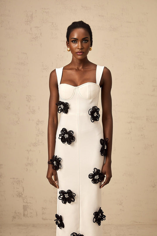 A long white bandage style maxi dress with floral applique details named Olivia