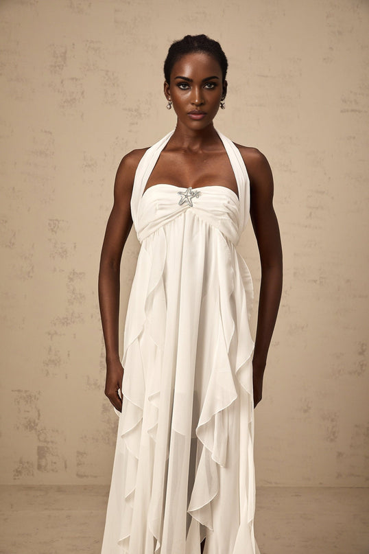 A long white chiffon maxi dress with a halter neck and ruffle details named Mariah