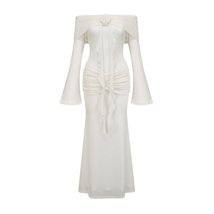 A long white knit maxi dress with glittered floral appliques adorning the fabric named Wanda