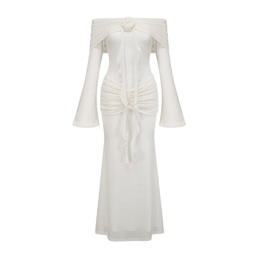 A long white knit maxi dress with glittered floral appliques adorning the fabric named Wanda